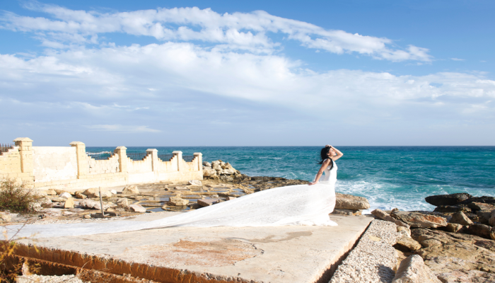 happy bride standing on a rock