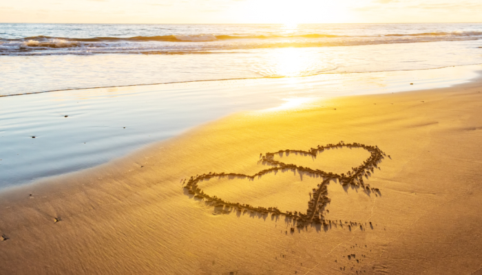 couple hearts on a sand beach