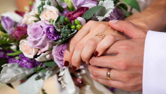 hands of bride and groom with rings on